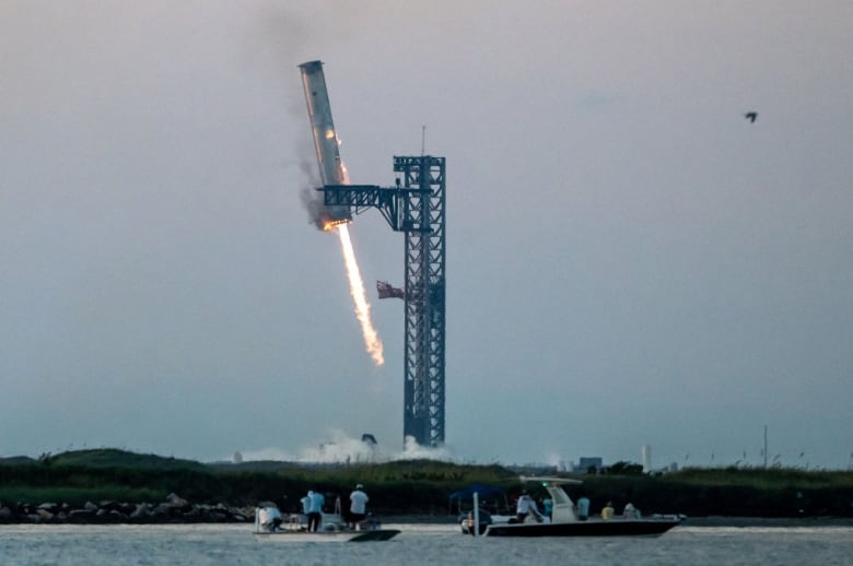 Launch tower's 'chopsticks' catch descending rocket booster as SpaceX launches Starship | CBC News
