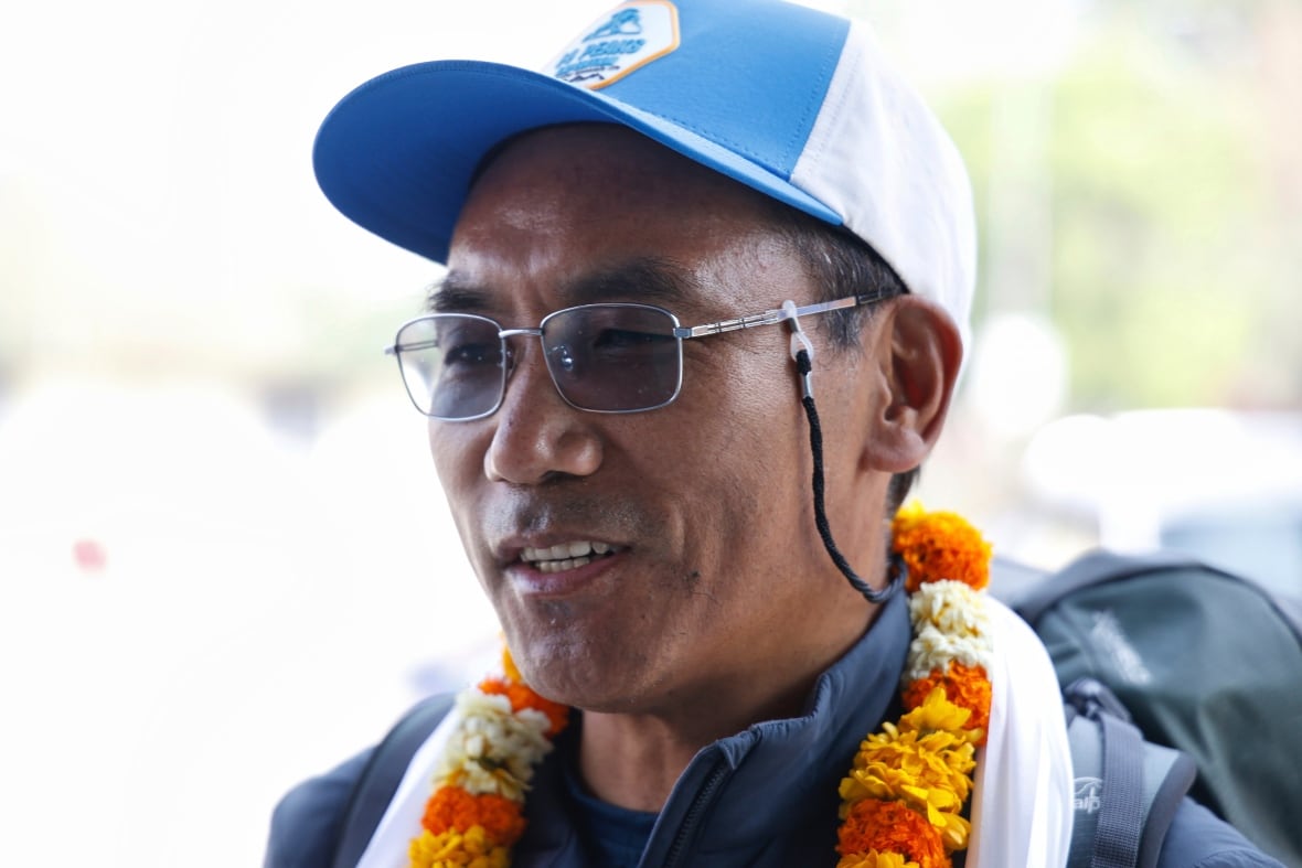 Sherpa guide breaks record by making 31st summit of Mount Everest