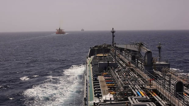 What is the Strait of Hormuz and what could happen to oil prices if Iran shuts it down?