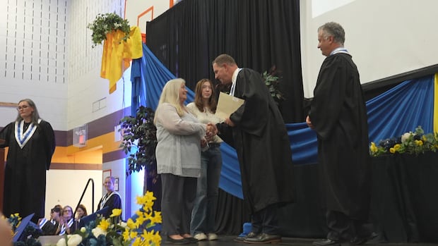 At this adult high school, 6 siblings celebrate graduation while a mom accepts her daughter's diploma