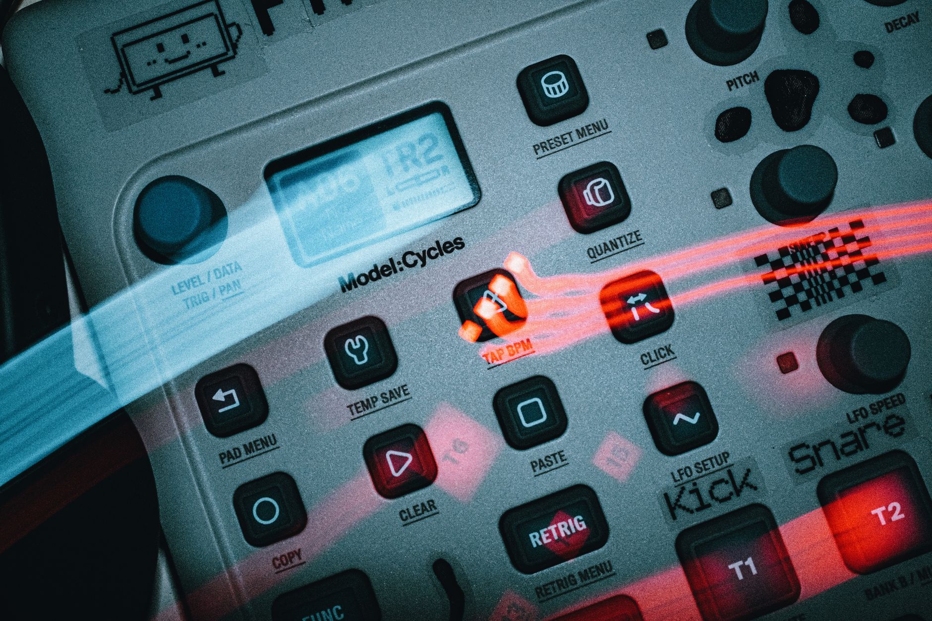 Detailed view of an electronic music sequencer with buttons and dials, showcasing a sleek design.