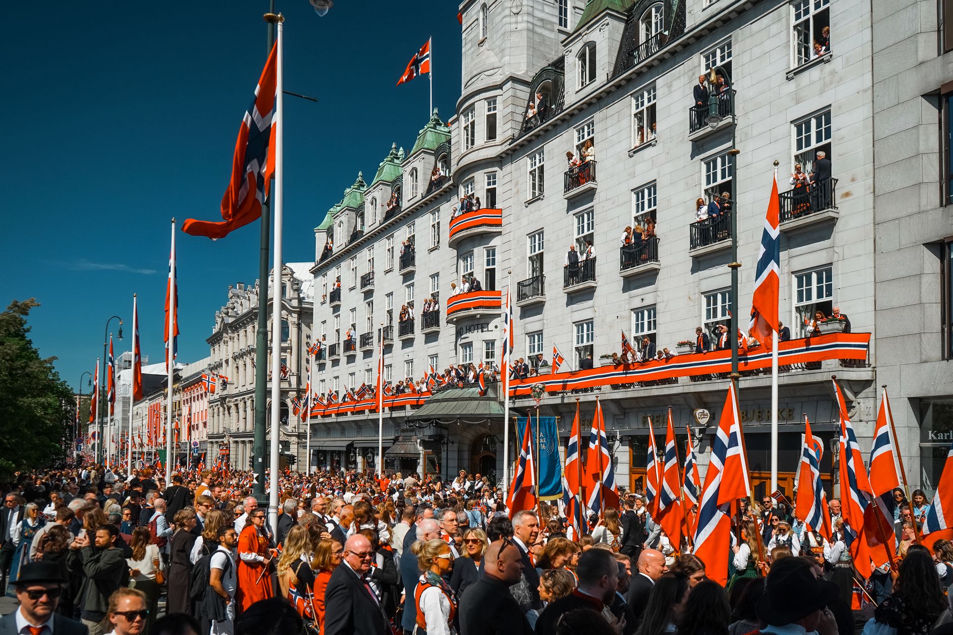 Vibrant street celebration in Oslo during Norwegian Constitution Day.