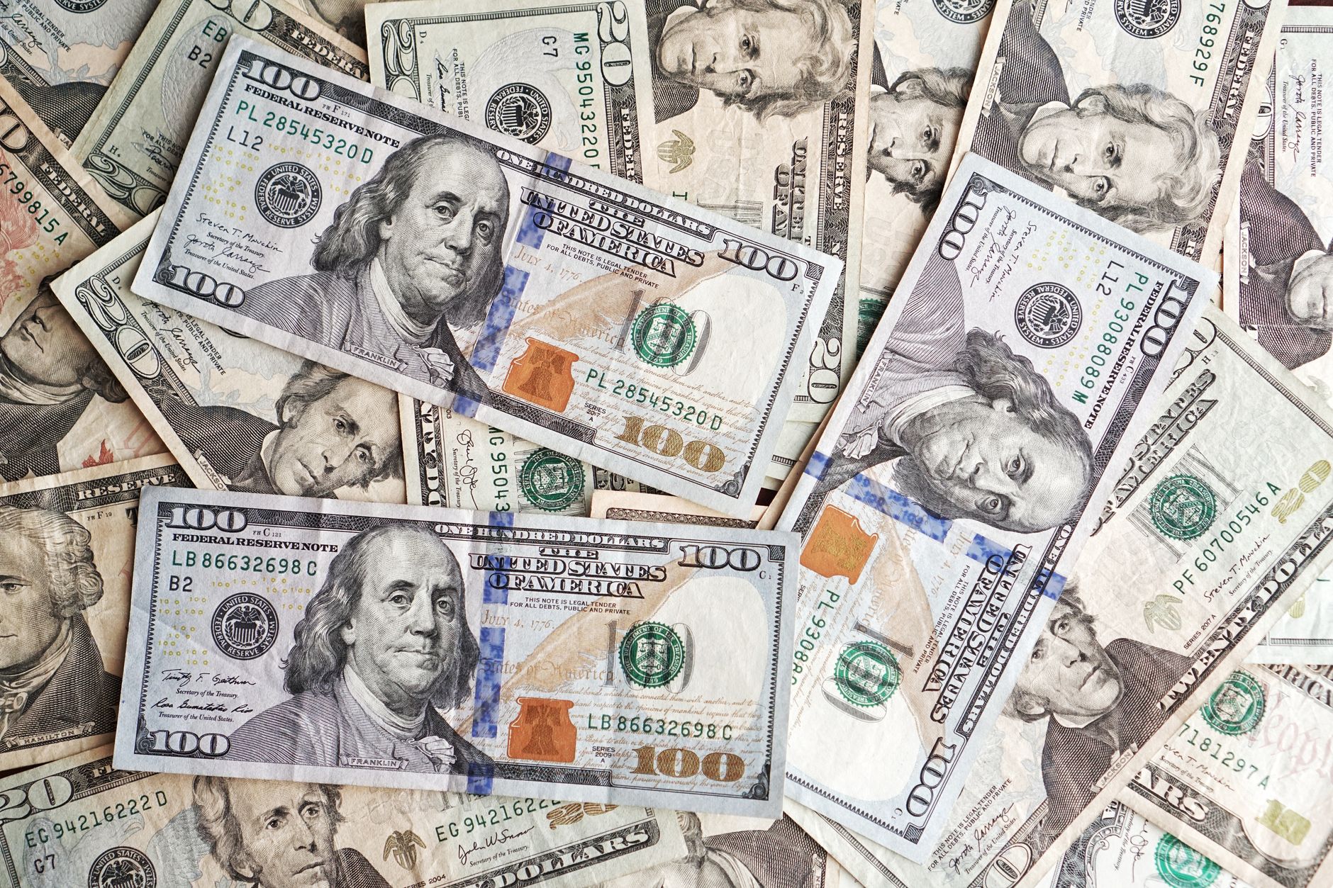 Close-up of various denominations of US dollar banknotes arranged in a pile representing finance and economics.