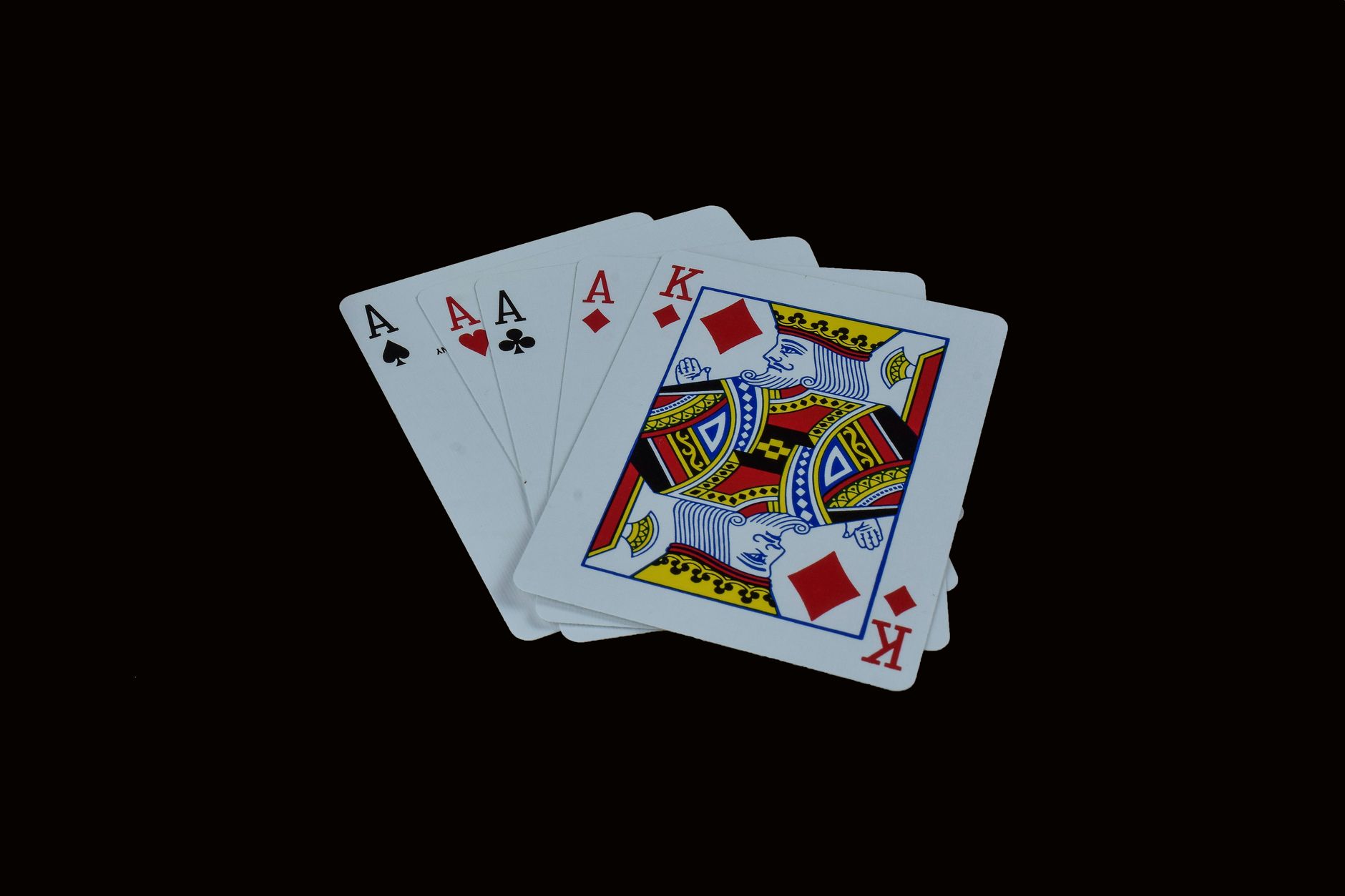 A striking image of four aces and a king on a black background, representing poker royalty.
